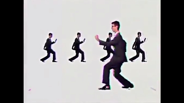 Screenshot, "Once in a Lifetime." Byrne as pugilistic cog in the machine.