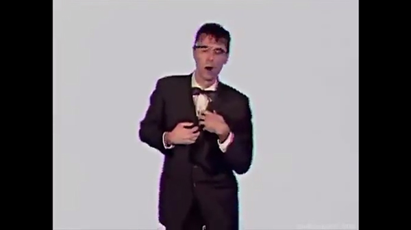 Screenshot, "Once in a Lifetime." Byrne in the middle of his spasms.