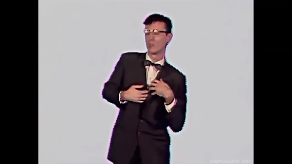 Screenshot, "Once in a Lifetime." Byrne continues to spasm.