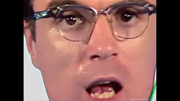 Screenshot, "Once in a Lifetime." A sweaty Byrne repeats "same as it ever was".