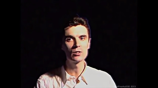 Screenshot, "Once in a Lifetime." Byrne the "rock star" stays in control without visible sweat.